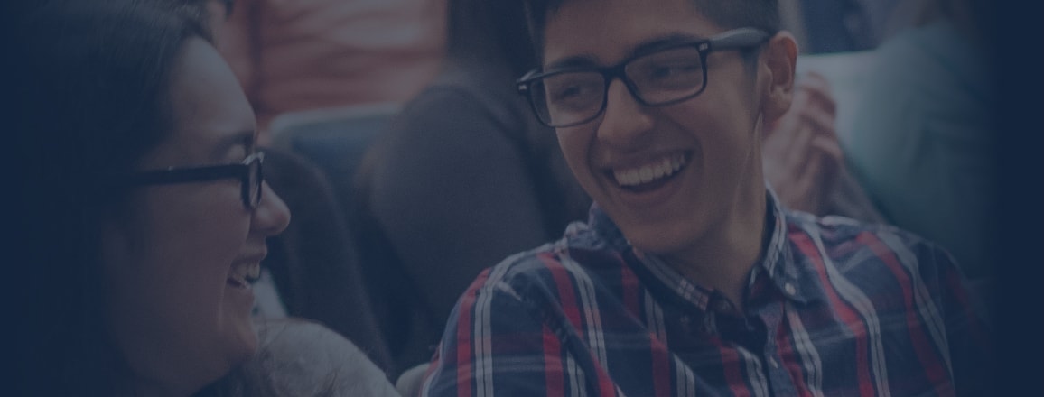 a picture of students smiling facing each others